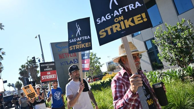 SAG-AFTRA and WGA members and supporters participate in picket line in support of SAG-AFTRA and WGA's walkout at Netflix Studios on July 14, 2023 in Los Angeles, California.