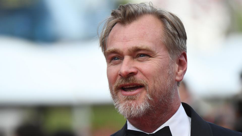 Christopher Nolan looks into the distance at the Cannes Film Festival in a tuxedo