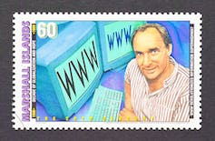A pencil drawing on a stamp showing a smiling man next to two computer screens with www