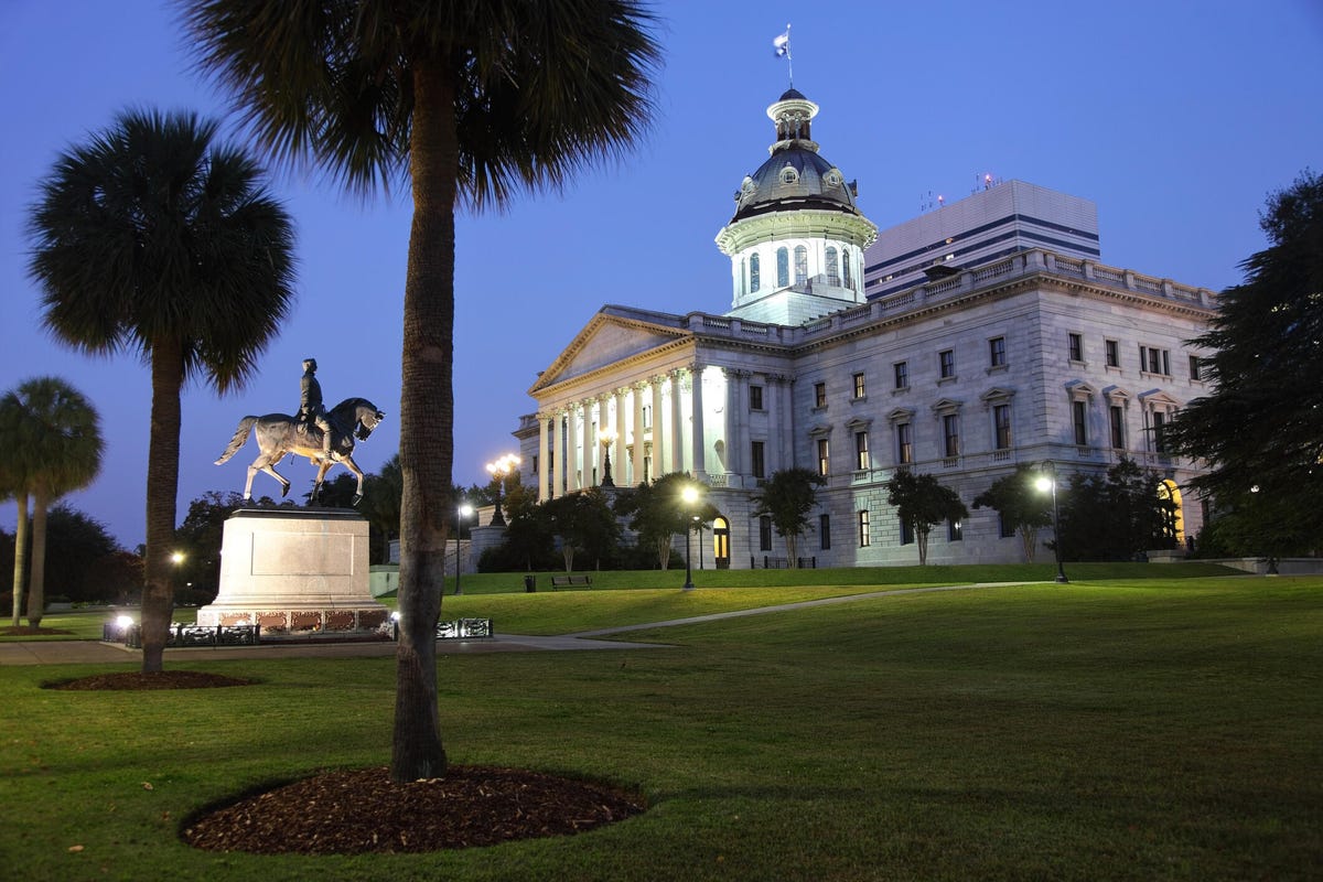 Evening view of the South Carolina State House in Columbia, South Carolina. The Wade Hampton statue sits behind the South Carolina Statehouse.